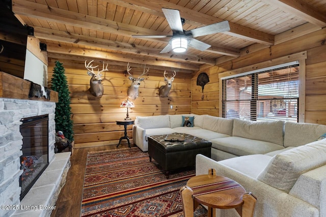 living room with a fireplace, wooden walls, wood finished floors, wooden ceiling, and beamed ceiling