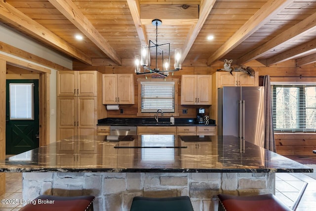 kitchen featuring a large island, light brown cabinets, appliances with stainless steel finishes, and a sink