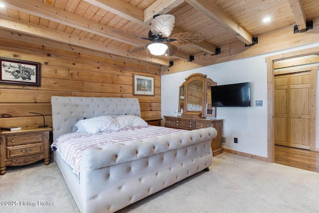 bedroom featuring wood ceiling, light colored carpet, wooden walls, and beam ceiling