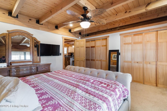 bedroom featuring wood ceiling, beam ceiling, two closets, and light colored carpet