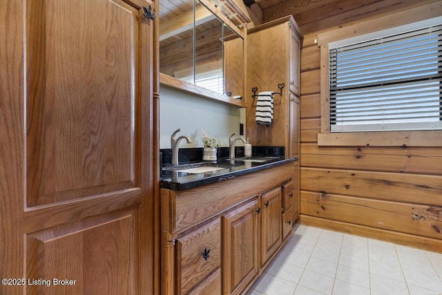 bathroom featuring tile patterned flooring, wood ceiling, wood walls, and vanity