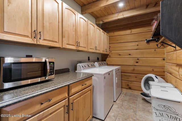 washroom featuring light tile patterned floors, cabinet space, wooden ceiling, washer and dryer, and wood walls