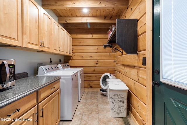 laundry room with light tile patterned flooring, wood walls, wood ceiling, independent washer and dryer, and cabinet space