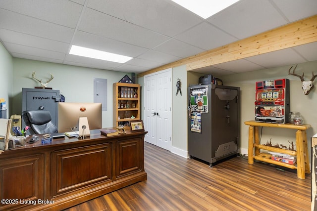 office area with a drop ceiling and wood finished floors