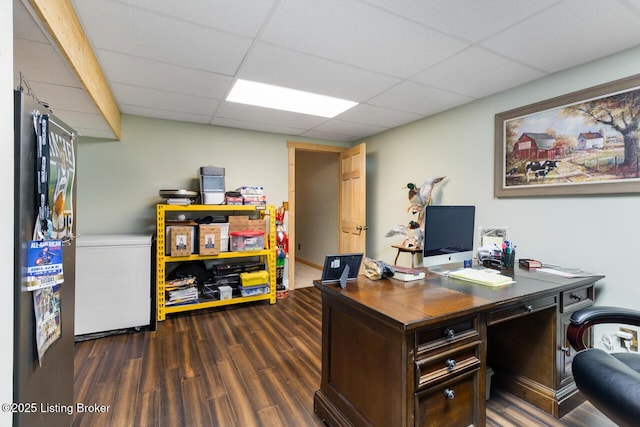 office area featuring a paneled ceiling and dark wood-type flooring