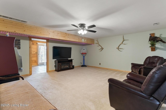 living area featuring light carpet, a fireplace, and visible vents