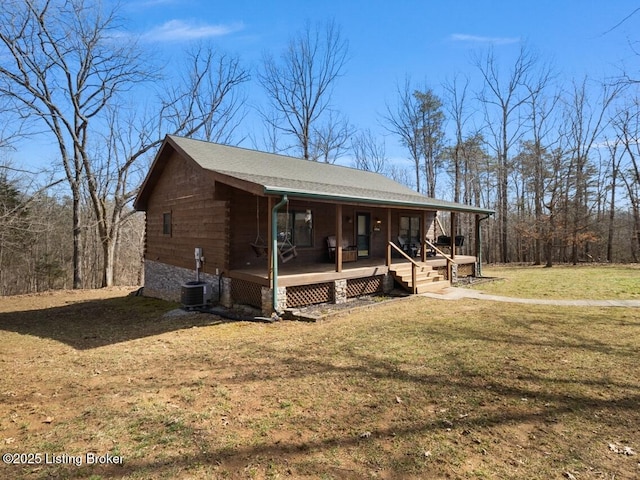 view of front of property featuring central air condition unit, a porch, a shingled roof, a front yard, and log siding