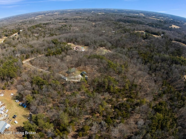 drone / aerial view featuring a forest view