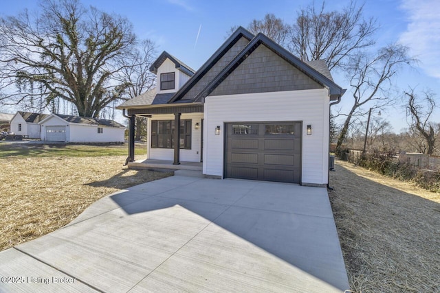 view of front of home with a garage, covered porch, and driveway