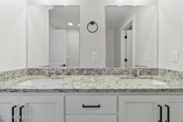 bathroom with double vanity and a sink