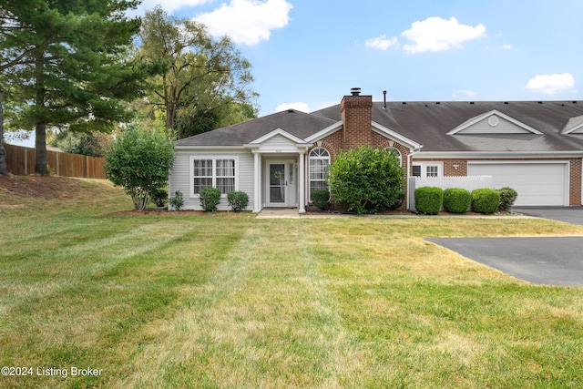 single story home with driveway, a garage, a chimney, fence, and a front yard