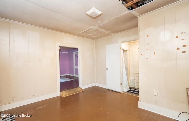 empty room with concrete floors and baseboards