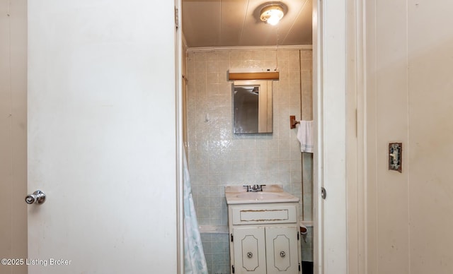 bathroom featuring tile walls and vanity