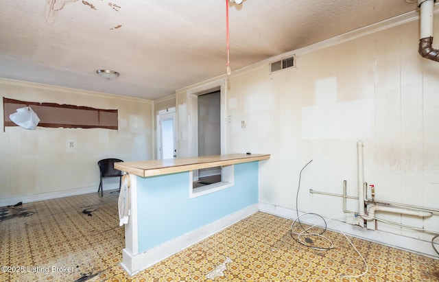 kitchen featuring visible vents, baseboards, and tile patterned floors