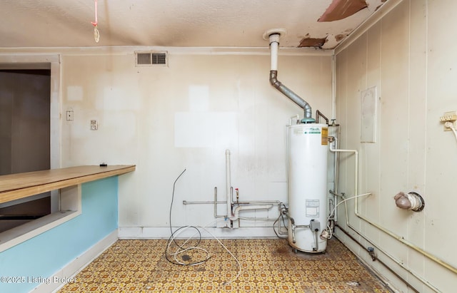 utility room with water heater and visible vents