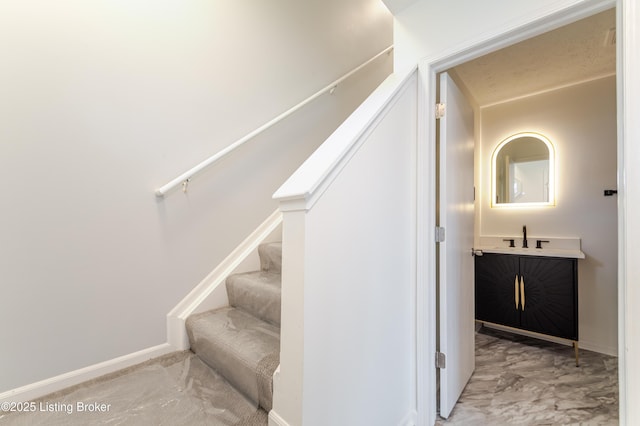 staircase featuring baseboards