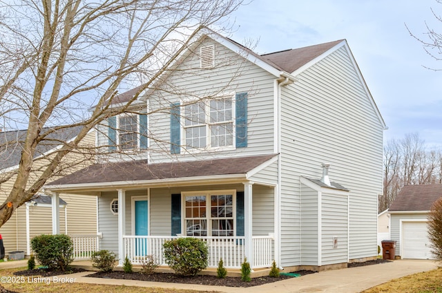 traditional home with a garage, a porch, and an outdoor structure