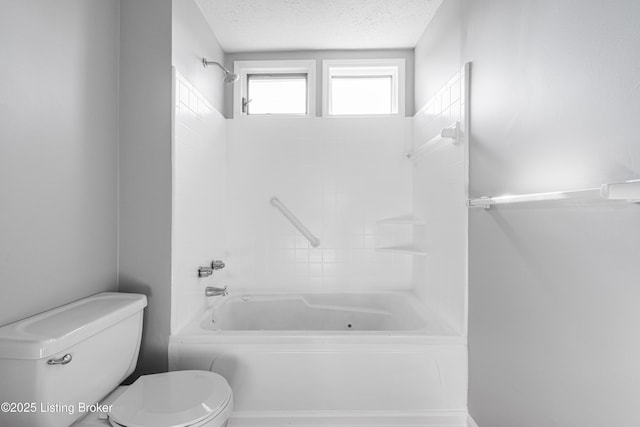 full bathroom featuring shower / bathing tub combination, a textured ceiling, and toilet