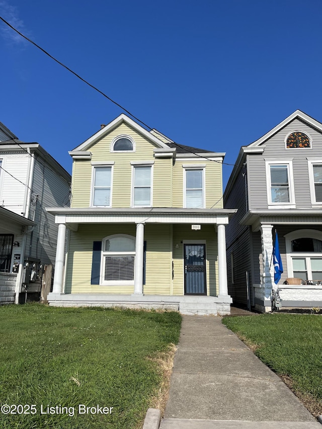 traditional-style house with a front lawn and a porch