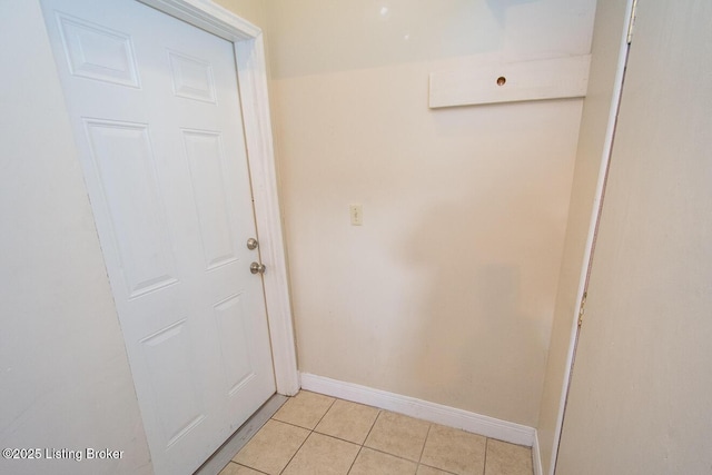 entryway featuring baseboards and light tile patterned flooring