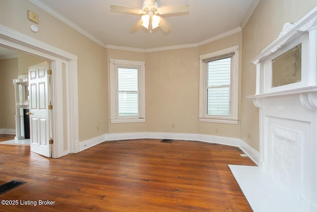 interior space featuring dark wood-type flooring, ornamental molding, and baseboards