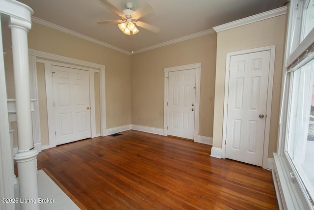 bedroom featuring dark wood-type flooring, ornamental molding, baseboards, and decorative columns