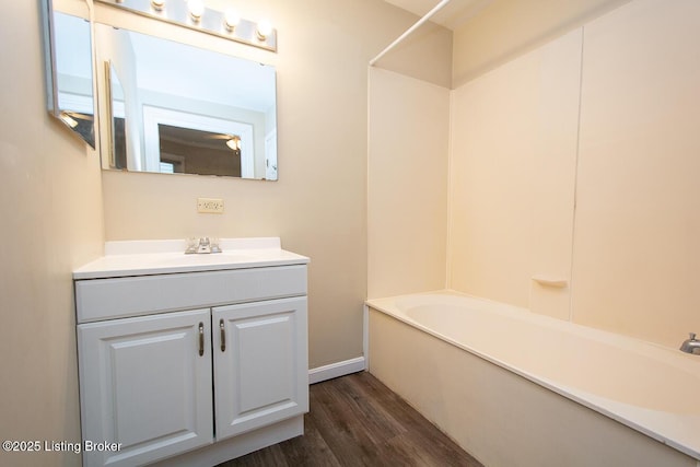 full bathroom featuring shower / washtub combination, wood finished floors, and vanity