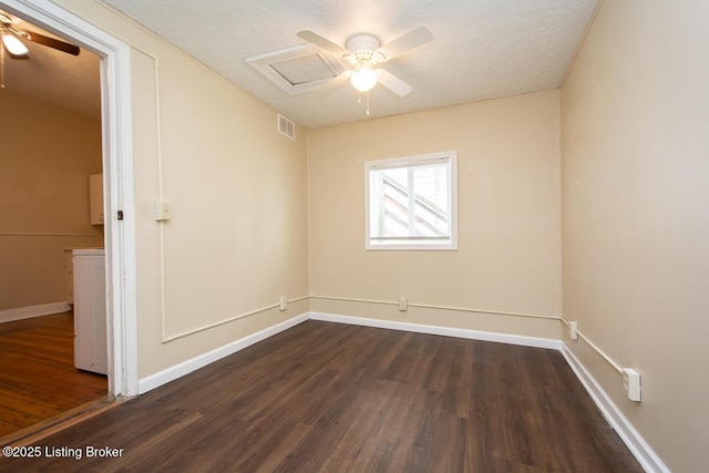 spare room with ceiling fan, a textured ceiling, dark wood-style flooring, visible vents, and baseboards