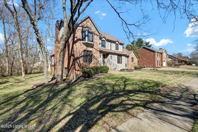 tudor home featuring a front yard