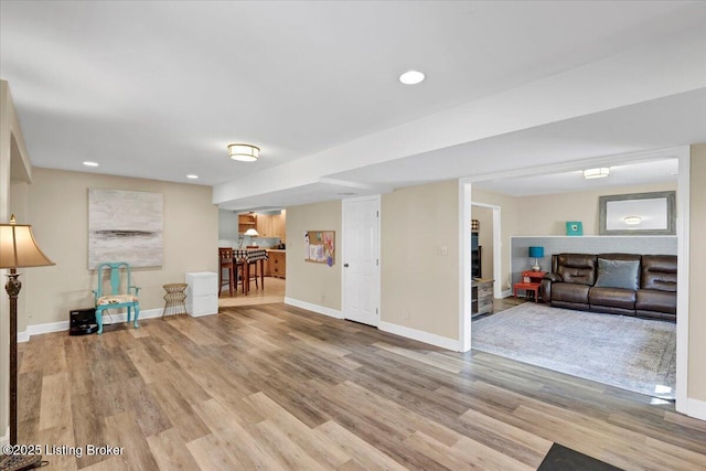 below grade area featuring recessed lighting, wood finished floors, and baseboards