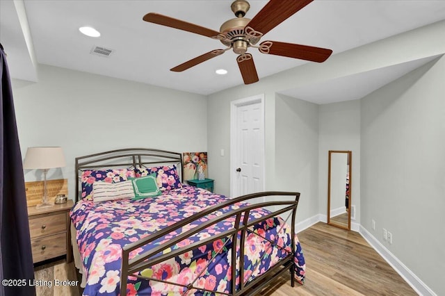 bedroom with recessed lighting, wood finished floors, a ceiling fan, visible vents, and baseboards