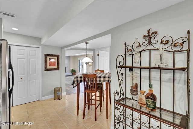 dining area featuring visible vents, baseboards, and light tile patterned floors