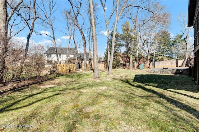 view of yard featuring fence and a playground