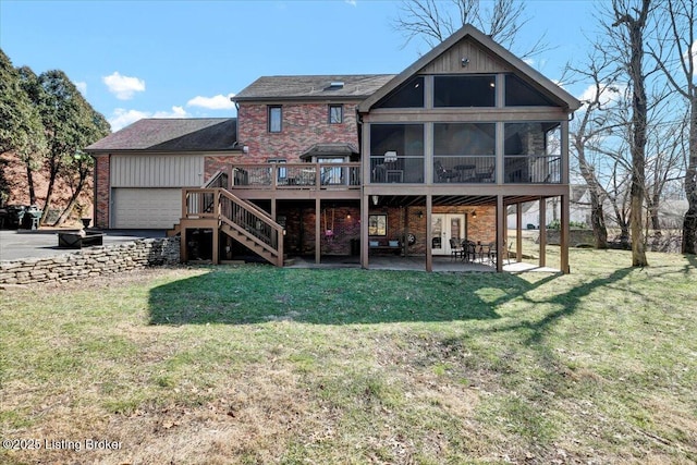 back of property with a lawn, a sunroom, stairs, a patio area, and brick siding