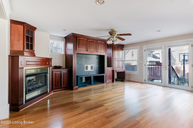 unfurnished living room with a fireplace, a ceiling fan, wood finished floors, and recessed lighting