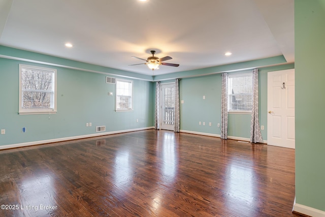 unfurnished room with recessed lighting, a ceiling fan, visible vents, baseboards, and dark wood-style floors