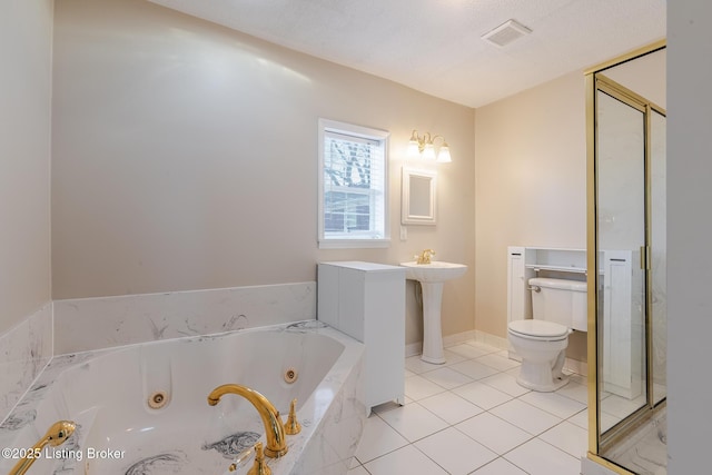 full bathroom featuring visible vents, toilet, a textured ceiling, tile patterned flooring, and a tub with jets