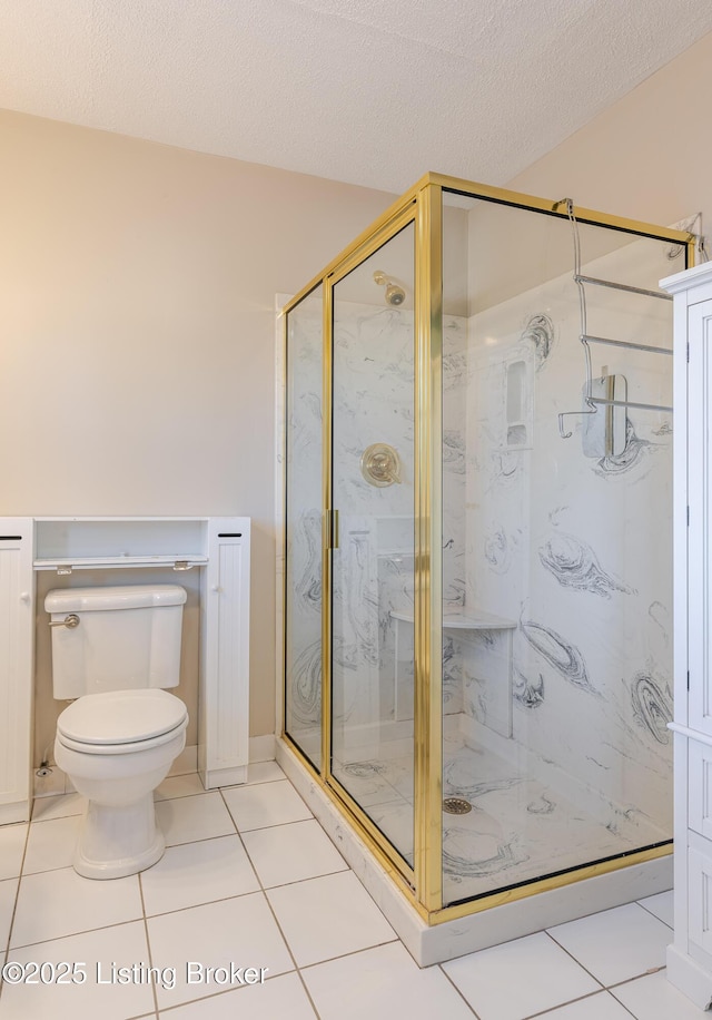 full bathroom featuring a textured ceiling, a marble finish shower, toilet, and tile patterned floors