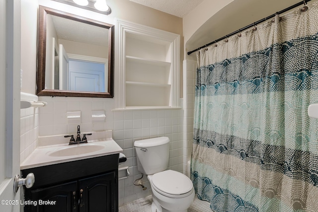 full bathroom featuring a textured ceiling, toilet, vanity, tile walls, and a shower with curtain