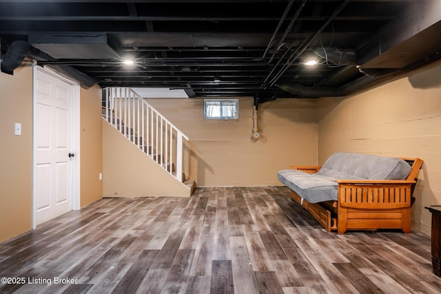 below grade area with stairway and wood finished floors