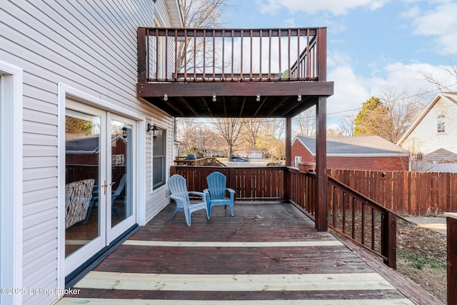 deck featuring french doors and fence