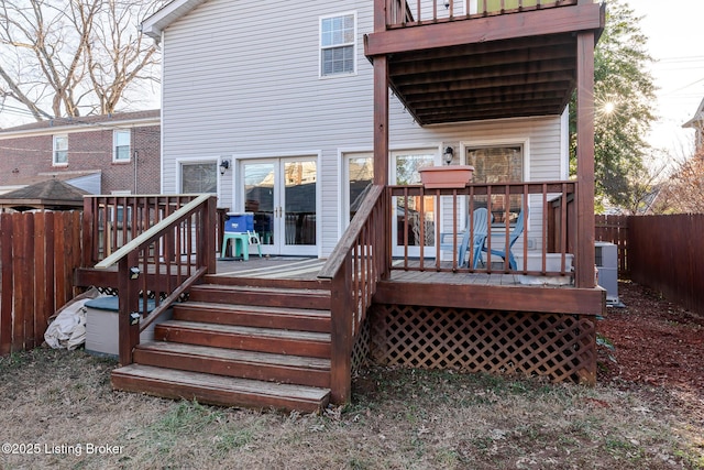 back of house featuring fence and a deck