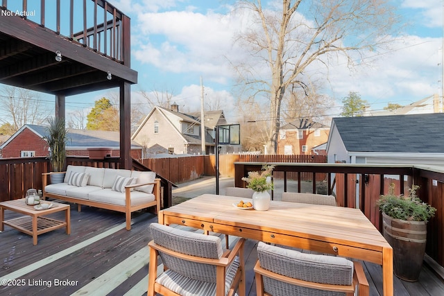 wooden terrace with a residential view, outdoor lounge area, and fence