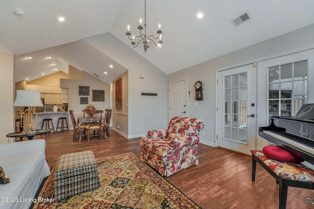 living room featuring french doors, visible vents, vaulted ceiling, wood finished floors, and baseboards