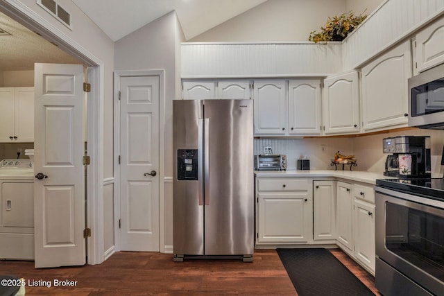 kitchen featuring stainless steel appliances, visible vents, light countertops, dark wood-style floors, and washer / clothes dryer