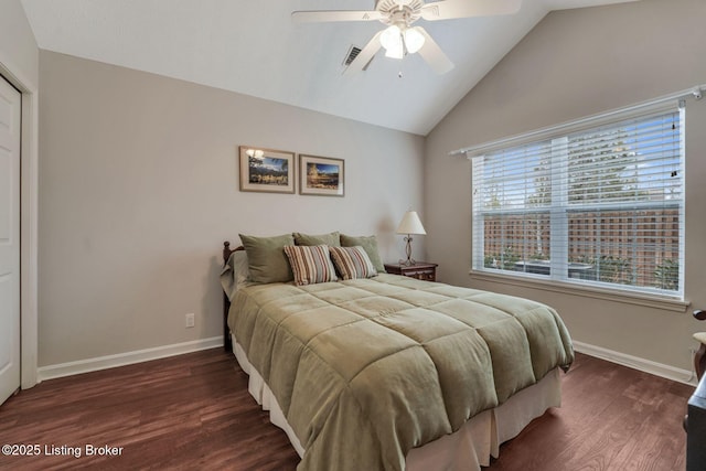 bedroom featuring visible vents, baseboards, vaulted ceiling, and wood finished floors