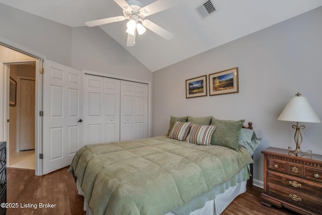 bedroom featuring lofted ceiling, a closet, visible vents, and wood finished floors