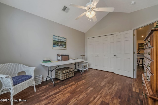 office space featuring baseboards, visible vents, ceiling fan, wood finished floors, and vaulted ceiling