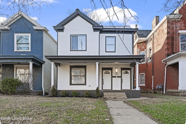 traditional home featuring a porch and a front yard