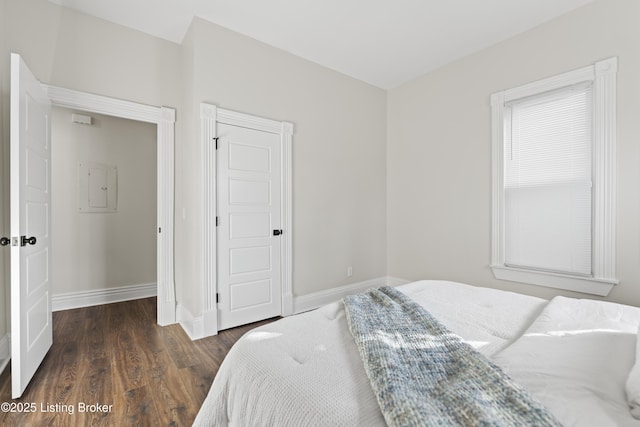 bedroom featuring baseboards and dark wood-type flooring